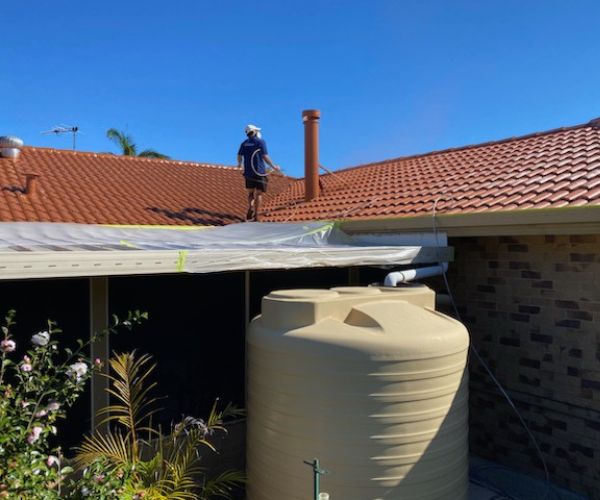 person using pressure cleaning equipment to complete Burrum Heads house washing request